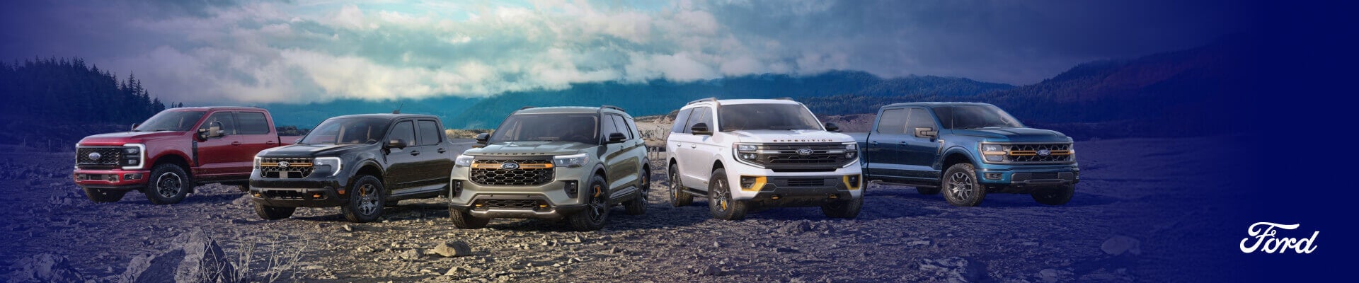 A lineup of 2026 Ford Trucks and SUVs parked in a rocky forest clearing.